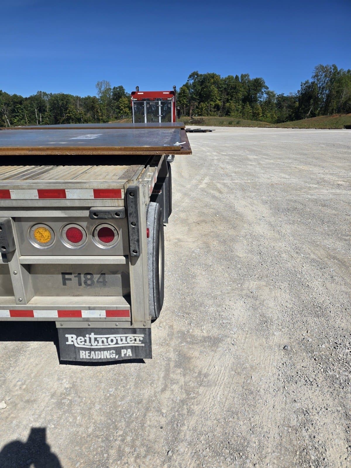 Large steel plate overhanging a flatbed trailer